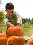 Young Boy Carving Pumpkins