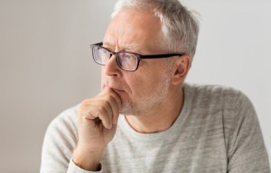 65060843 - old age, problem and people concept - close up of senior man in glasses thinking