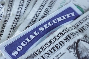 8753830 - a social security card surrounded with dollar bills
